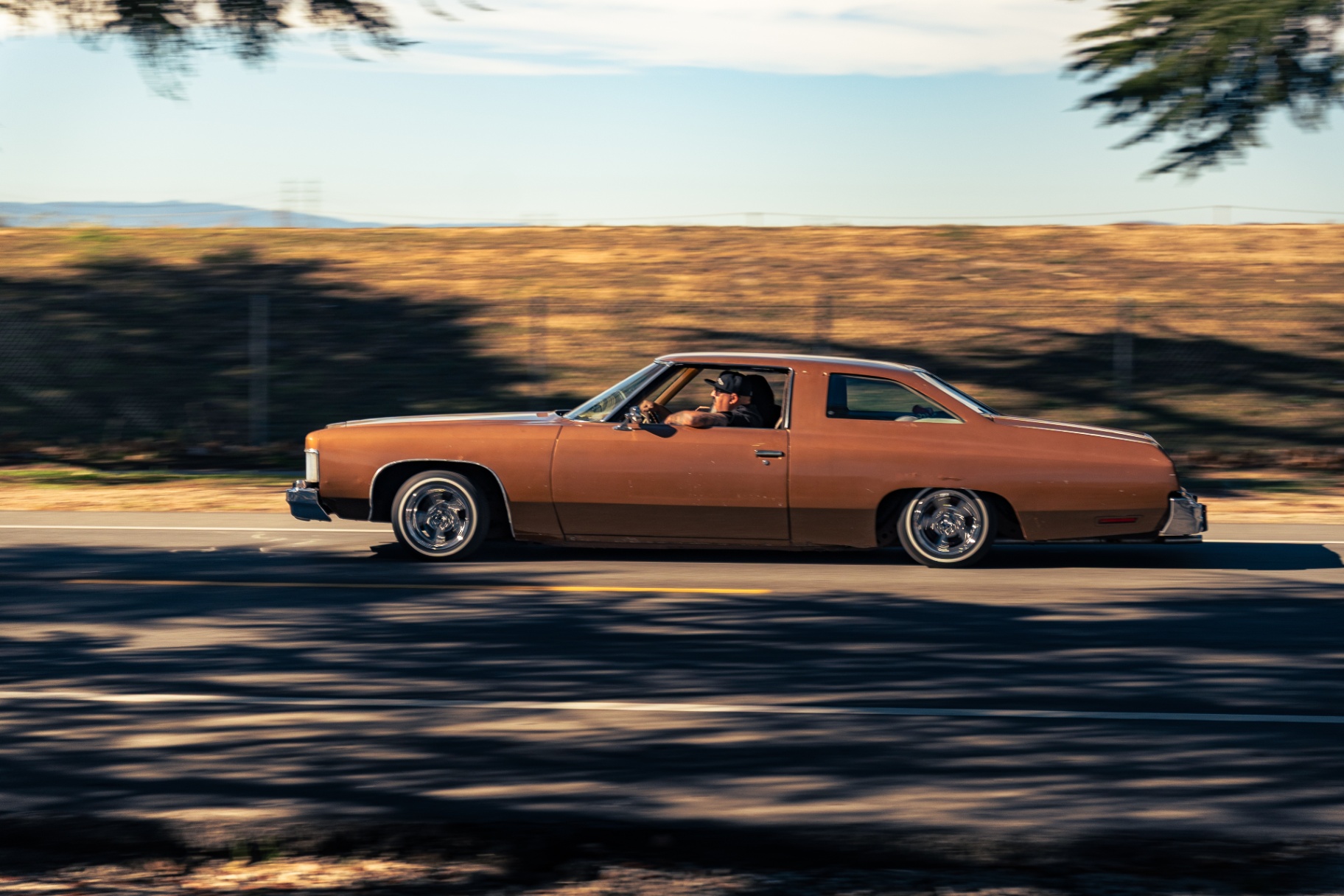 Bronze classic Chevy Impala rolling through the cruise