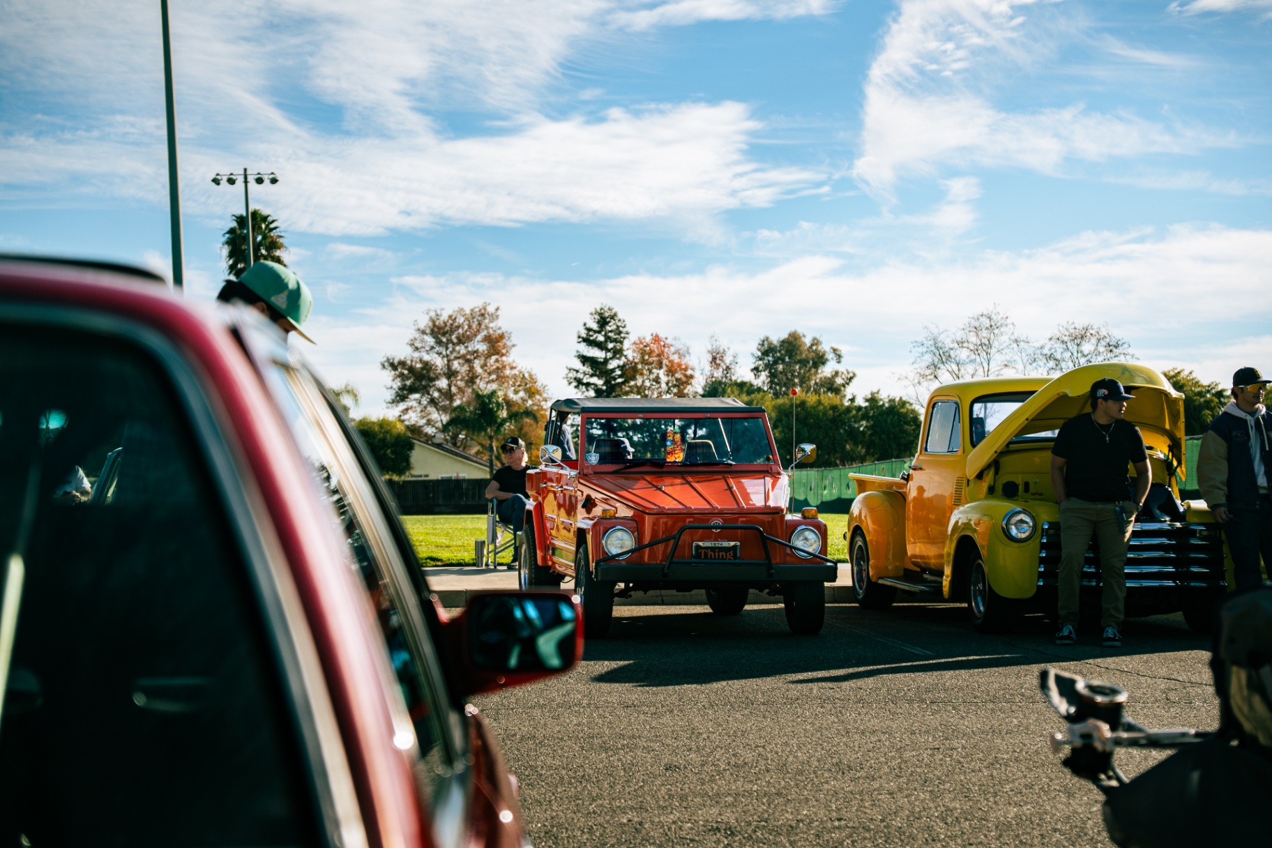 Volkswagen Thing and classic pickup lined up under blue skies