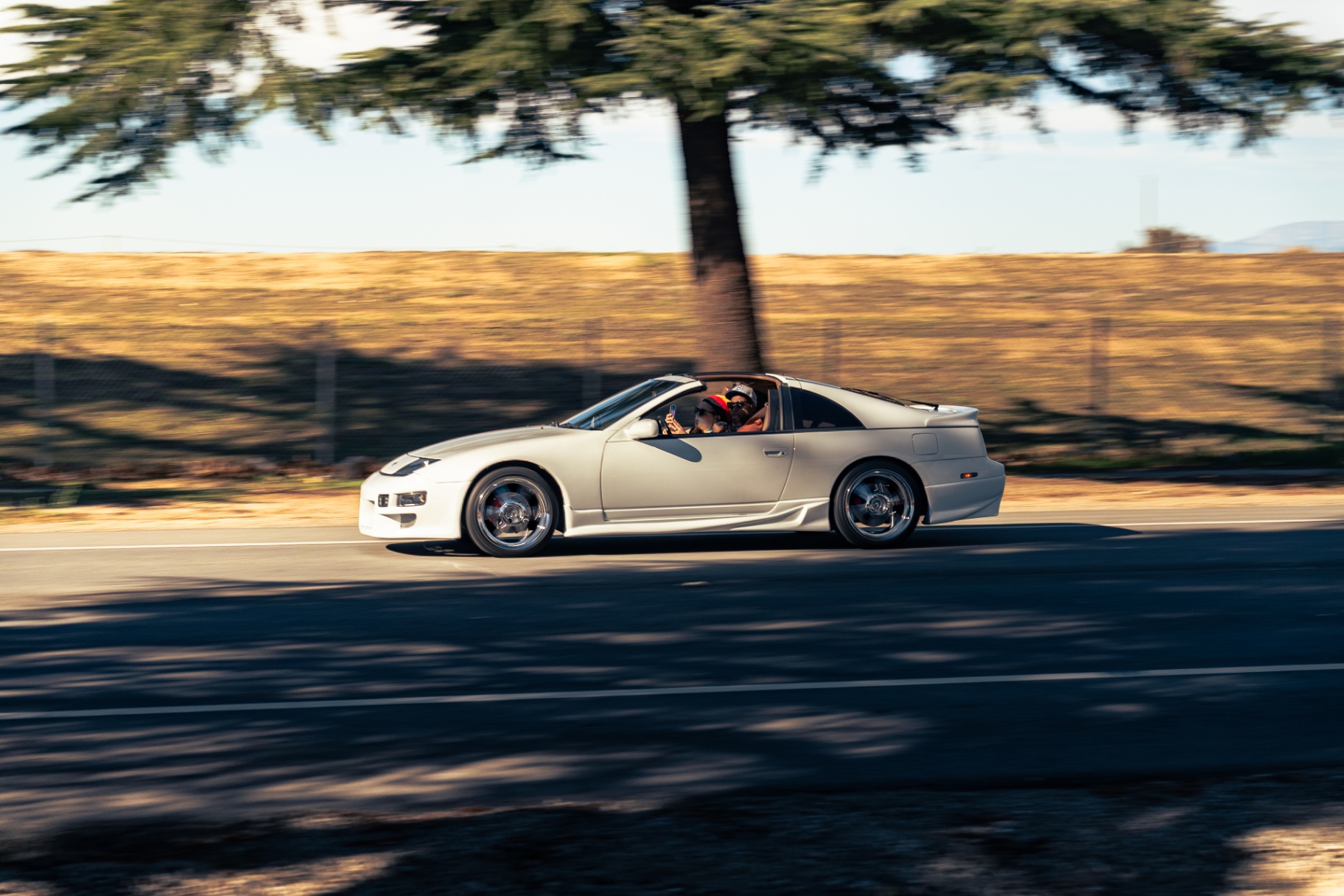 White Nissan 300ZX panning shot on the open road