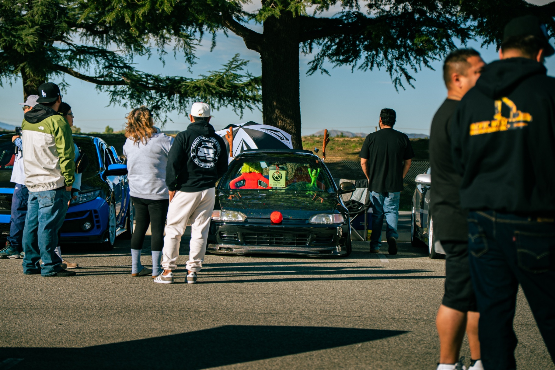 Crowd gathered around a stanced Civic with reindeer antlers