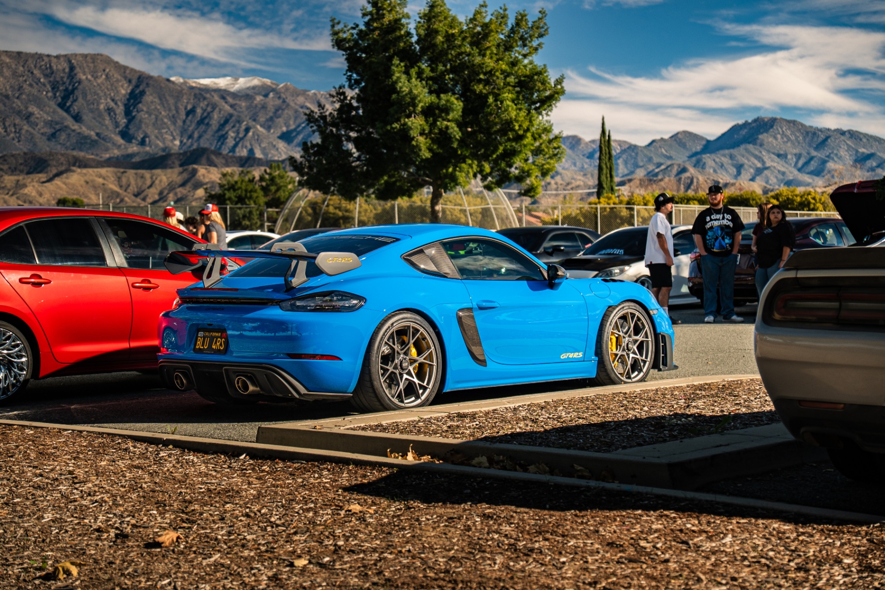 Miami blue Porsche 718 Cayman GT4 RS with mountain backdrop